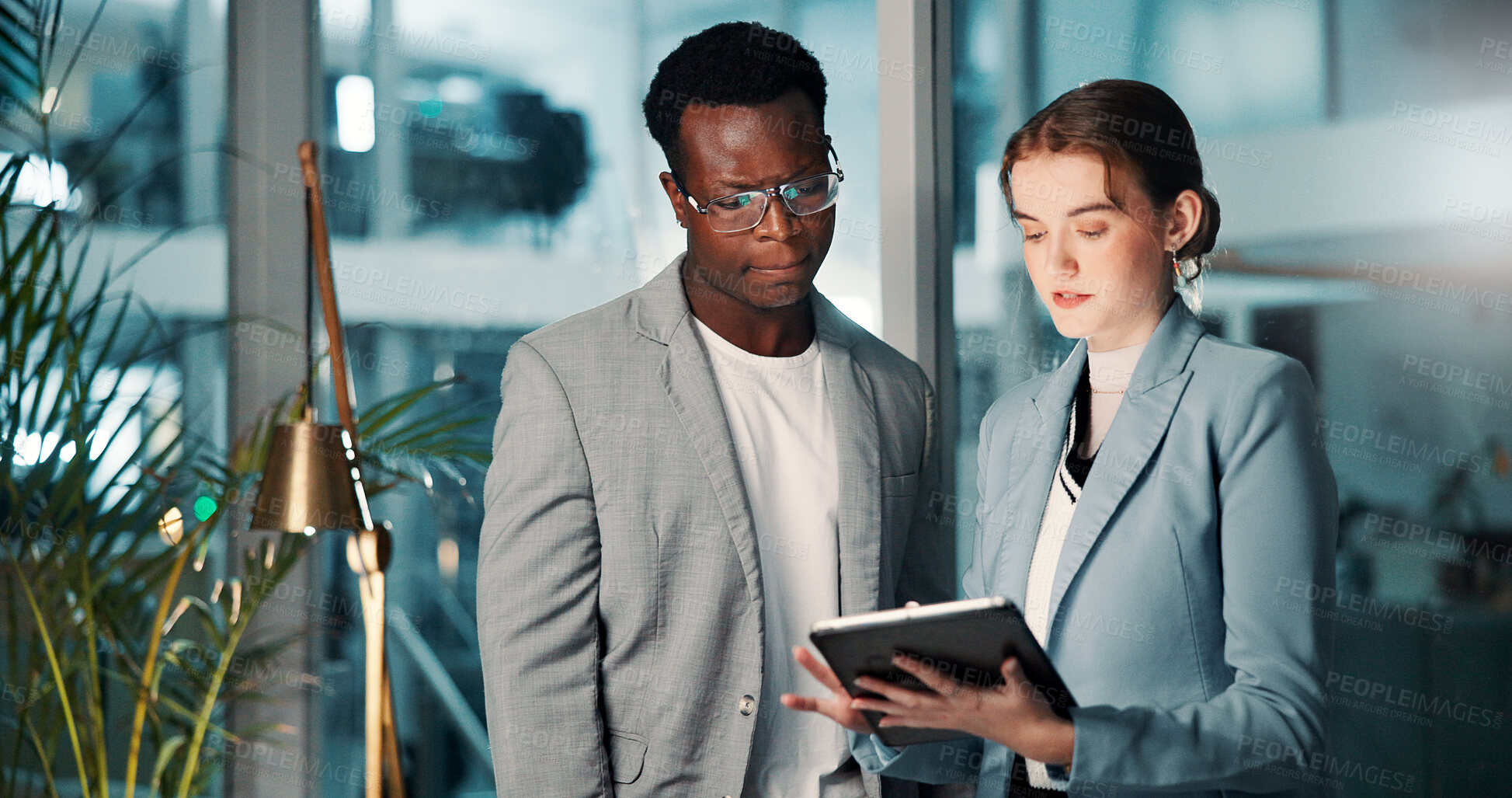 Buy stock photo Business people, tablet and team discussion at night for deadline, progress update or project management. Meeting, planning and brainstorming with tech in office for budget, schedule or development