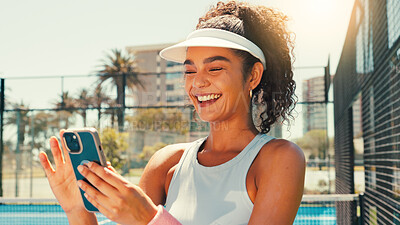 Buy stock photo Tennis, happy and woman on court with phone, social media or scroll on training app for exercise tips. Athlete, smile or mobile on sports ground for tournament results, fitness or club registration