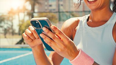 Buy stock photo Tennis, hands and woman on court with mobile, social media or scroll on training app for exercise tips. Athlete, smile or phone on sports ground for blog update, fitness research or club registration