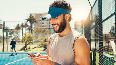 Buy stock photo Tennis, happy and man on court with phone, social media or scroll on training app for exercise tips. Athlete, typing or mobile on sports ground for blog update, fitness progress or tournament results
