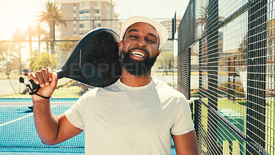 Buy stock photo Happy man, portrait and paddle tennis with racket for sport, game or match on outdoor court. Face, male person or athletic player with smile, hat or bat for friendly competition, challenge or fitness