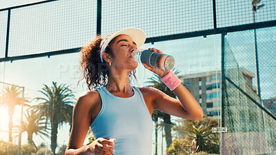 Buy stock photo Sports, drinking water and woman on tennis court for rest, thirst hydration and wellness outdoors. Fitness, athlete and person with bottle after training, exercise and workout for padel practice