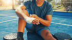 Sports, hands and person with bandage, outdoor and accident from game, fitness and wound with inflammation. Ground, injury and athlete with bruise in morning, hurt and recovery from swollen muscle