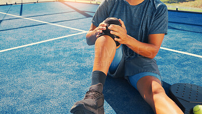 Buy stock photo Brace, knee pain and man on tennis court with injury, medical crisis and accident outdoors. Fitness, health and person with ache, strain and tension from training, workout and exercise for padel game