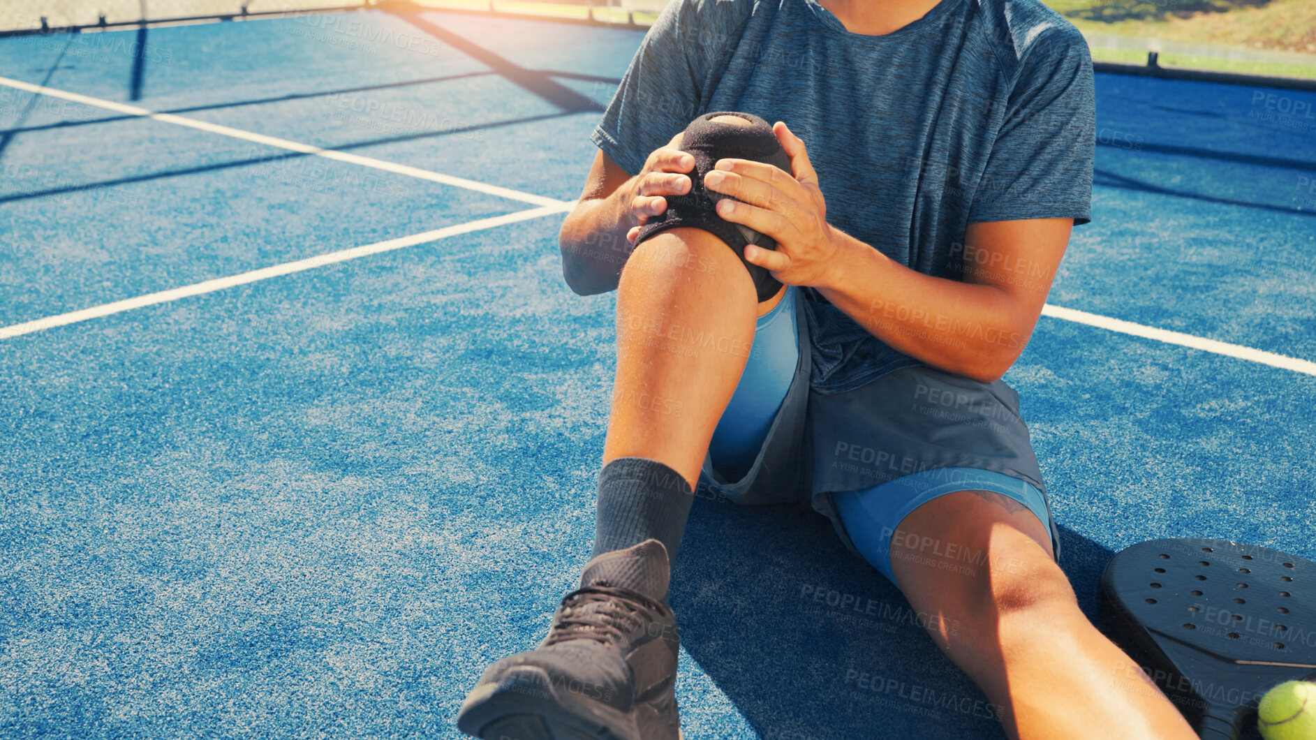 Buy stock photo Brace, knee pain and man on tennis court with injury, medical crisis and accident outdoors. Fitness, health and person with ache, strain and tension from training, workout and exercise for padel game