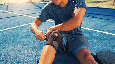 Buy stock photo Sports, knee pain and man on tennis court with injury, medical crisis and accident outdoors. Fitness, health and person with brace, strain and hurt from training, workout and exercise for padel game