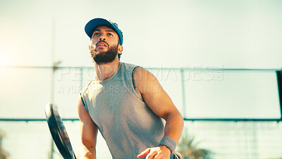 Buy stock photo Outdoor, athlete and man with padel racket, skills and serious for performance with fitness and active. Court, player and below with equipment for practice, workout and training for competition