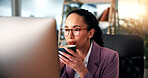 Woman, business and drinking coffee at computer with glasses, morning routine and reading in office. Professional, reflection or mug in workplace for article review, email or journalist at technology
