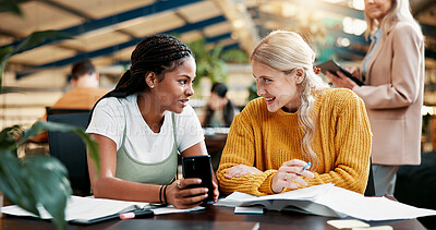 Buy stock photo Happy, people and friends with phone in library for social media, university gossip and good news. Students, talking and mobile for education schedule, learning website and online rumor for knowledge