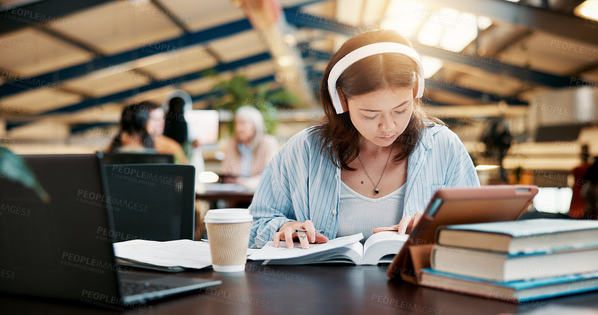Buy stock photo Music, reading book and woman learning in university library for knowledge, research or listen to audio. Notebook, college and serious student with headphones to study for exam or education with tech