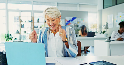 Buy stock photo Fist pump, laptop and success with happy woman at desk in office for goals or target. Bonus, celebration and winner with mature designer in creative workplace for achievement, deal or milestone