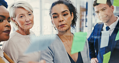 Buy stock photo Planning, glass wall and writing with business people in office for diversity or strategy. Brainstorming, collaboration and sticky notes with employee team in workplace for discussion or management
