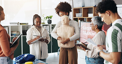 Buy stock photo First aid, training and people with choking dummy in office for abdominal thrusts, heimlich maneuver and life saving. Business, notes and emergency rescue for workplace safety and employee engagement