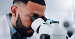 Man, forensic and scientist with microscope for analysis, exam or clinic trial at laboratory. Male person, science or discovery with microscopic technology for DNA, test results or medical research