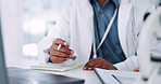 Hands, book and doctor in hospital with research for healthcare consultation preparation. Pen, notes and closeup of surgeon planning surgery schedule with medical insurance information in clinic.