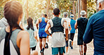Running, marathon and back of people in park for charity event, race challenge and fitness. Training, fundraising competition and exercise with group of runners in nature for performance and sports