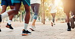 Running, race and shoes of people in park for workout, marathon challenge and fitness. Training, speed competition and exercise with closeup of runners feet on ground for performance and sports