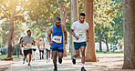 Running, competition and race with people in park for charity event, health challenge and fitness. Training, fundraising marathon and exercise with group of runners in nature for workout and sports