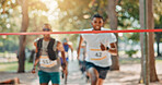Running, marathon or people with finish line in park for charity event, health challenge or fitness. Speed, fundraising competition or fast runners in nature for outdoor workout, exercise or sports