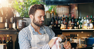 Buy stock photo Barman, happy and glass for cleaning, dust and hygiene with cloth for drinks service at restaurant. Person, bartender and shine with smile, job and career with wipe for dirt removal at small business