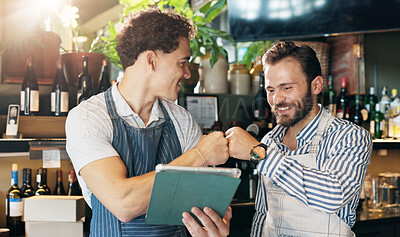 Buy stock photo Waiter, team and tablet in restaurant with fist bump, positive online review and happy for order increase. Service industry, men or tech in bar for digital menu, hospitality or excited for shift list