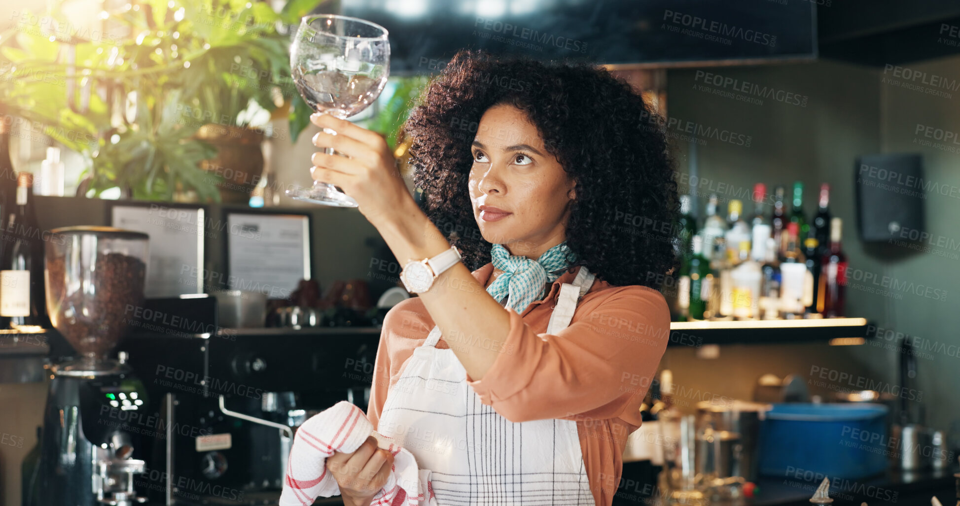 Buy stock photo Woman, bartender and cleaning glass with cloth for hygiene, dust or service for drinks at restaurant. Person, waiter and check for dirt with smile, shine and career with inspection at small business