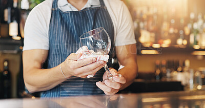 Buy stock photo Waiter, hands and cleaning glass with cloth for hygiene, dust and service for drinks at restaurant. Person, bartender and check for shine with wipe, germs and inspection for dirt at small business