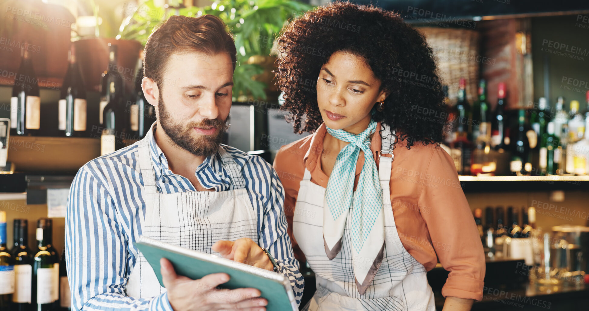 Buy stock photo Small business, online and colleagues with tablet, bar and inventory of stock for wine and collaboration. Discussion, woman and man with tech for sales, alcohol and ideas for promotion of restaurant