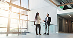Meeting, business and people talk in lobby with discussion, planning and feedback for convention. Woman, man and explaining schedule with communication, event agenda and advice for keynote speaker