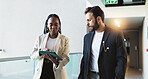 Business, people and walking with tablet in office for investment feedback, performance review and discussion. Financial analyst, teamwork and digital app for finance forecasting or report generation