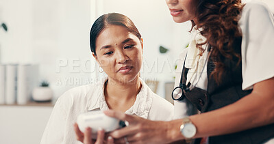 Buy stock photo Doctor consulting and blood pressure with women in hospital for healthcare advice, test and cardiovascular results. Medical assessment, hypertension diagnosis and wellness with people in clinic