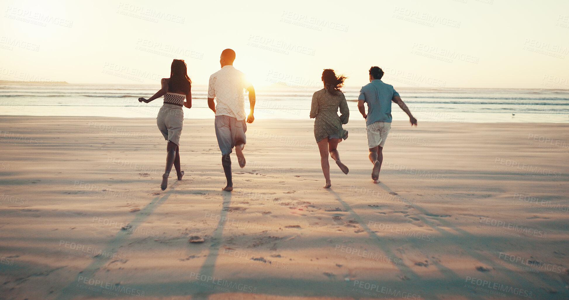 Buy stock photo Running, sunset and back of friends on beach for tropical vacation, break or holiday together. Freedom, energy and group of people by ocean for seaside weekend trip for travel with activity in summer