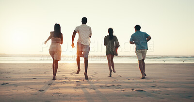 Buy stock photo Running, sunset and back of people on beach for tropical vacation, break or holiday together. Freedom, energy and group of friends by ocean for seaside weekend trip for travel with activity in summer
