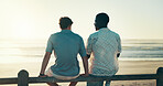 Back, beach and men with vacation, friends and conversation with tropical island. People, ocean and travel with summer holiday, weekend break and bonding together with discussion, sunset and seaside