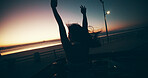 Sunset, freedom and woman in car for road trip, travel or adventure at beach outdoor. Hands up, vacation and  person in convertible for holiday, celebration or back view on journey with wind at dusk