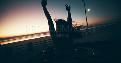Buy stock photo Sunset, freedom and woman in car for road trip, travel or adventure at beach outdoor. Hands up, vacation and  person in convertible for holiday, celebration or back view on journey with wind at dusk