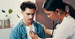 Doctor, patient and consultation for healthcare with stethoscope, chest exam or cardiology checkup. Medicine, health and people in hospital office for medical evaluation, listening to heart and help