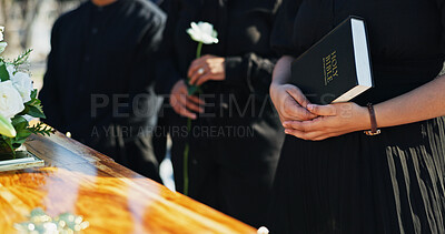 Buy stock photo Bible, hands and people by coffin at funeral for respect, blessing or spiritual comfort at graveyard. Religion, prayer and family by casket with holy book for grief, loss or farewell at burial.