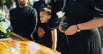 Hand, flower and woman by coffin for funeral ceremony, grief and memorial service outdoor with family. Rose, death and person by casket at graveyard for mourning, peace and farewell with respect
