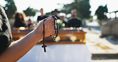 Buy stock photo Funeral, hands and person with rosary, ceremony and symbol for religious service, respect and graveyard. Outdoor, prayer and Christian with crucifix necklace for sermon, death and gospel in cemetery