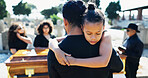 Girl, hug or father in graveyard for funeral, compassion or burial for death, support or crying with coffin. Child, embrace or sad kid in cemetery for grief, loss or mourning with dad and empathy