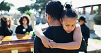 Child, hug or father in graveyard, compassion or burial for death, support or mourning with coffin. Girl, depressed or sad kid in cemetery for grief, loss or embrace with dad, crying and sympathy