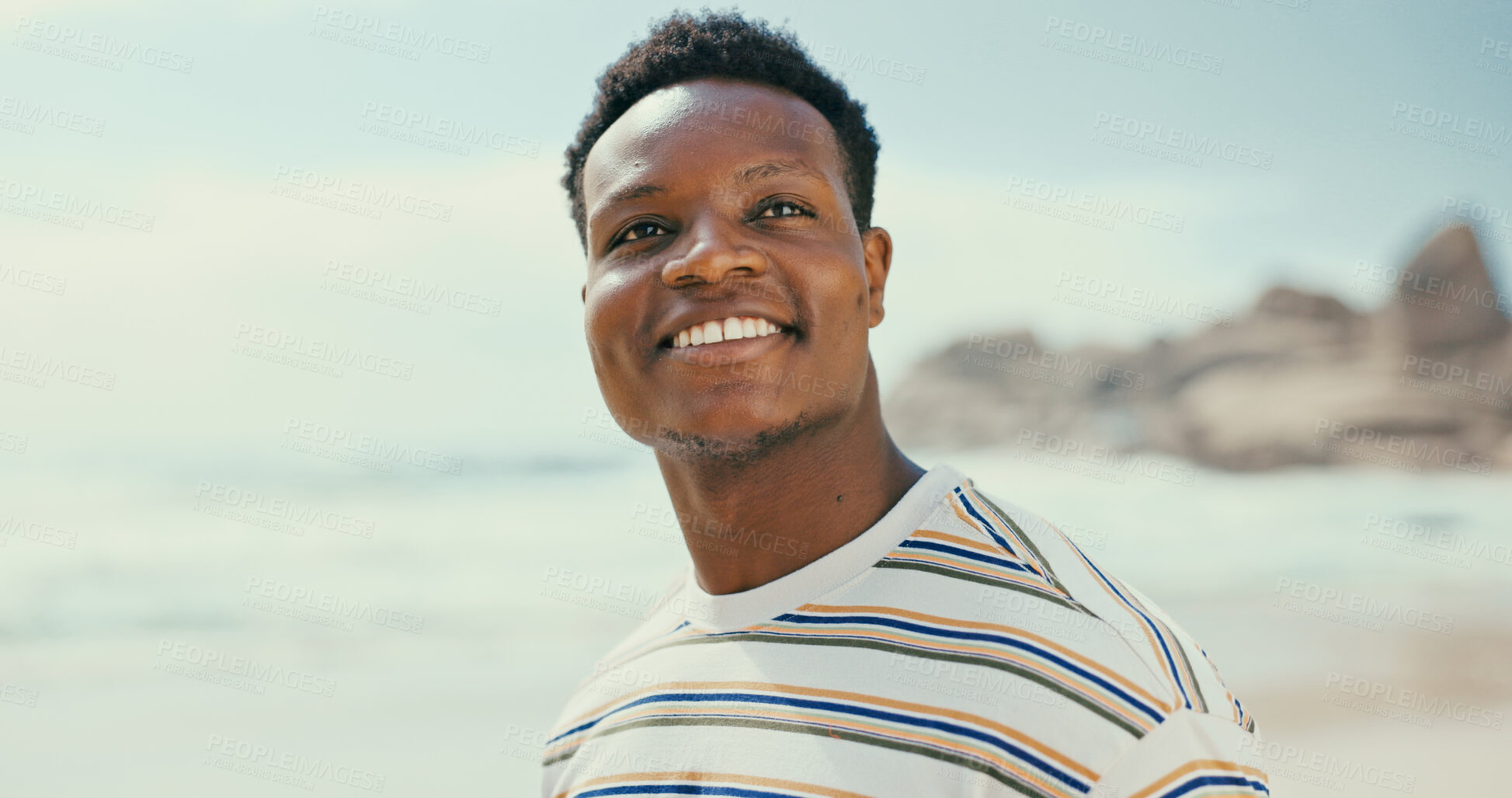 Buy stock photo Thinking, smile and black man at beach for holiday, vacation or outdoor travel for adventure. Sea, face or happy African person in nature at ocean for trip, summer or tourism ideas on island in Spain