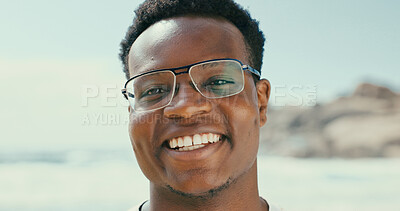 Buy stock photo Portrait, smile and black man at beach for holiday, vacation and travel outdoor for adventure. Ocean, tourism and happy person with glasses in nature at sea for trip, relax and summer in Seychelles