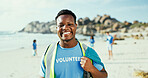 Man, portrait and plastic bag for cleaning beach with smile, outdoor and excited on earth day with care for environment. Person, volunteer and happy by sea for waste with trash, garbage and dirt