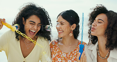 Buy stock photo Friends, women and blowing bubbles at beach for fun activity, travel adventure and laughing on holiday. Girls, people and bonding with toy wand for vacation support, weekend break and playing a game