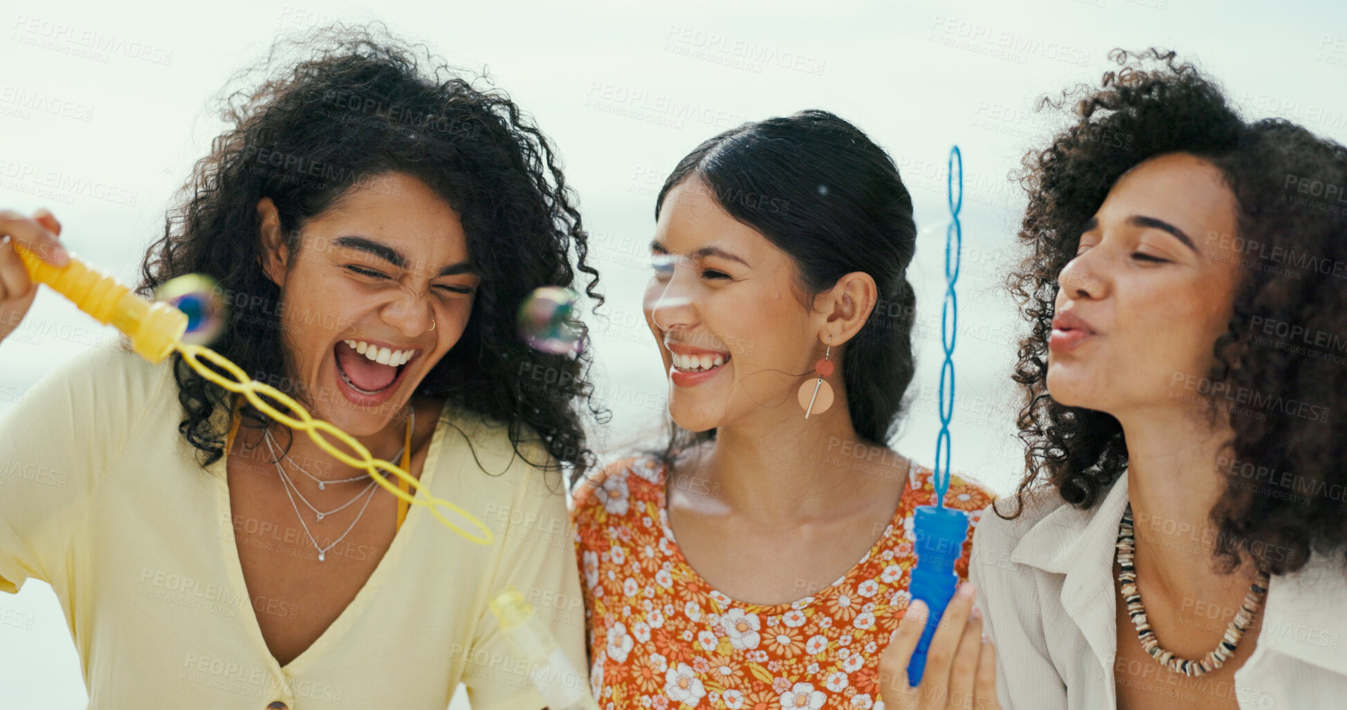 Buy stock photo Friends, women and blowing bubbles at beach for fun activity, travel adventure and laughing on holiday. Girls, people and bonding with toy wand for vacation support, weekend break and playing a game