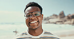 Portrait, smile and black man at beach for vacation, holiday and travel outdoor for adventure. Ocean, tourism and happy person with glasses in nature at sea for trip, relax and summer in Seychelles