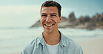 Portrait, smile and man at beach for vacation, holiday and travel outdoor for adventure. Ocean, confidence and happy person in nature at sea for trip, summer and tourist relax on island in Miami
