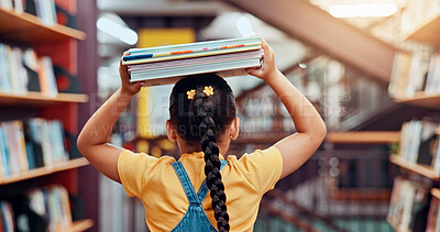 Buy stock photo Library, head and back of child with books for reading story, literature and learning. School student, bookshelves and girl with stack of novels for knowledge, education and language development